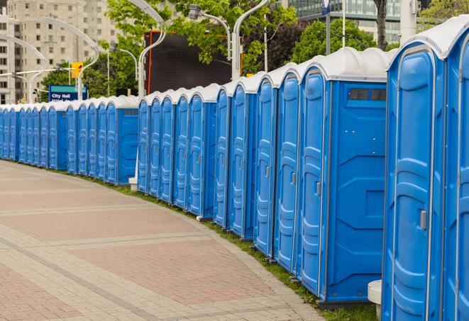 a row of portable restrooms at an outdoor special event, ready for use in Avon Lake